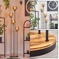 Hofstein Cesaro Stehlampe aus Metall/Holz/Glas in Schwarz/Natur/Bernsteinfarben